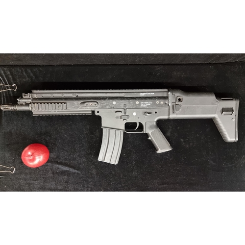 134 - An FN Herstal SCAR full metal Airsoft Rifle. With a 5.56mm calibre gun with electric gearbox. Featur... 