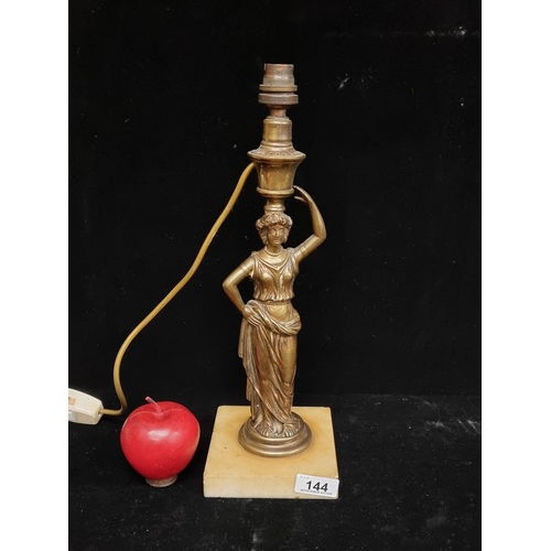 144 - A vintage, brass, figural table lamp. With a classical female lamp stem mounted on a white, alabaste... 