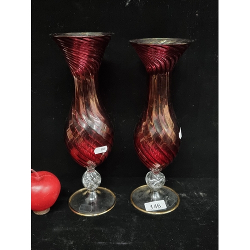 146 - A stunning pair of handblown, ruby glass vases with spiral form by Zodax brand. With a luster interi... 