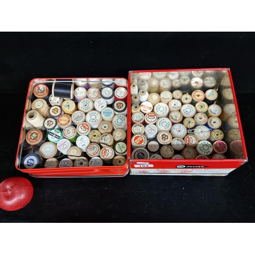 154 - Two antique tins filled with approximately eighty spools of thread. Including some high quality Iris... 