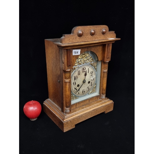 164 - A handsome antique eight-day mantle clock, housed in an attractive oak case, with original winder an... 