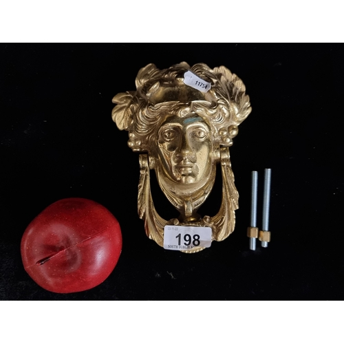 198 - A very heavy brass door knocker with a neo-classical mask head.