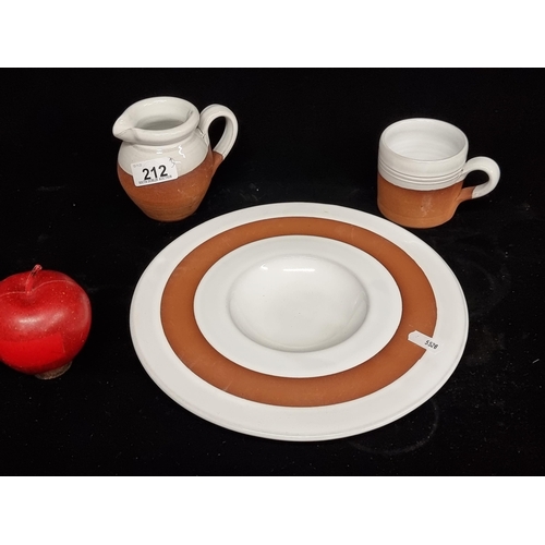 212 - Three pieces of Stephen Pierce terracotta ware including a plate, a jug and a cup, all finished in a... 