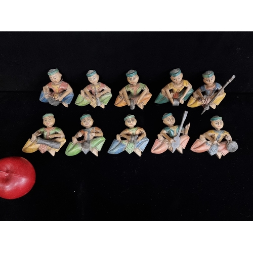 219 - 10 vintage carved wooden Thai musician figurines, with hooks on back for easy display.