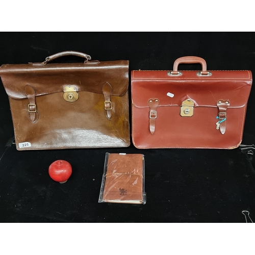 225 - Two vintage, leather briefcase bags. In a brown and red leather. Including one, sealed leather noteb... 