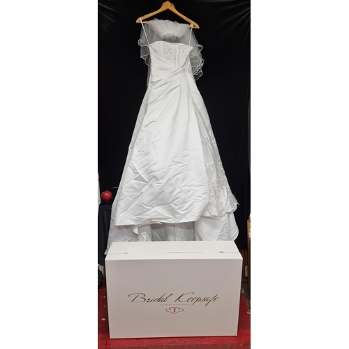 227 - A stunning Bridal Gown. A beautiful, classic Princess silhouette with boned corset featuring satin t... 