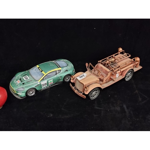 246 - Two model cars including an Aston Martin DBR9 (1/18) and a 1920s style firetruck with ladder and hos... 