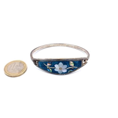 41 - An unusual Mexican sterling silver bangle, which features and attractive inlayed enamelled and abalo... 
