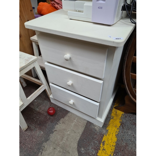 487 - A large bedside table with three pull drawers to front and rounded corners. 
MM: W56 x D46 x H74 cm