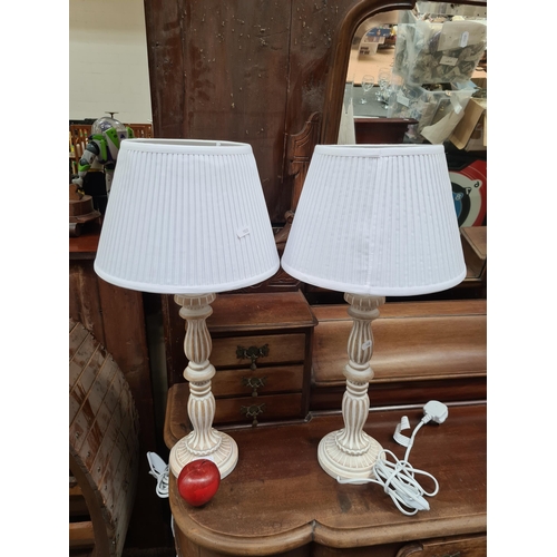 489 - Two lovely wooden table lamps with distressed white wash finish and pleated white shades.