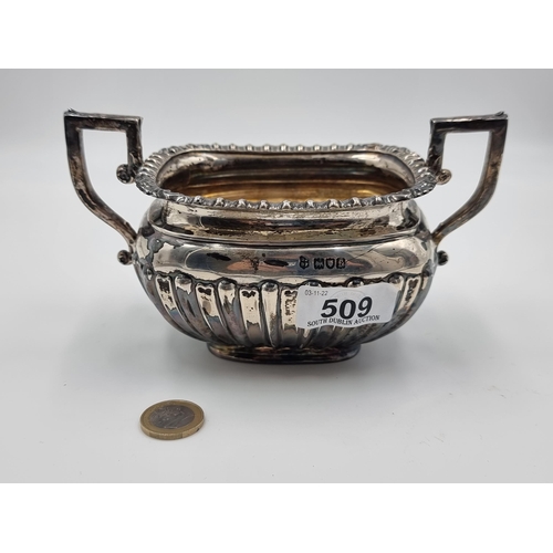 509 - Star Lot: A fine example of a generous sterling silver sugar bowl. This bowl features scroll handles...