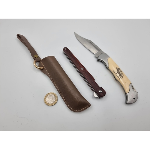 542 - Two good quality pen knives, the first is a wooden handle stiletto example with leather sheath and b... 