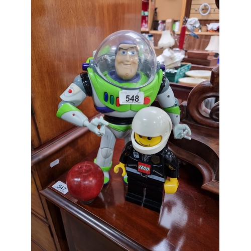 548 - Two collectable toys. Including a Disney Thinkway Buzz Lightyear figure circa 1996. With a LEGO ligh... 