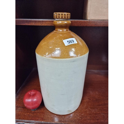 569 - A very heavy antique stoneware flagon with original stopper, in shades of cream and brown. In very g... 