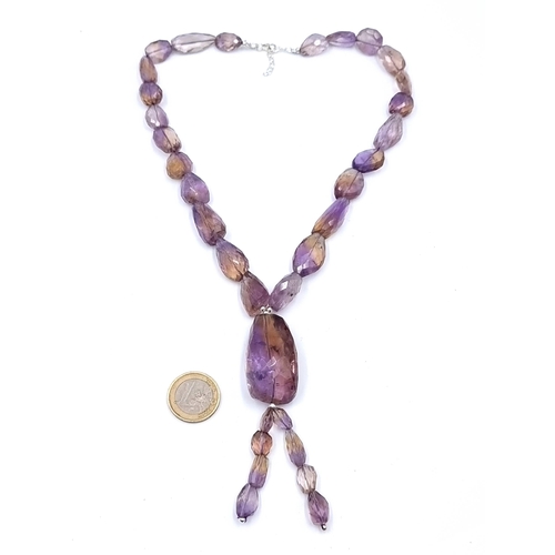 58 - An incredible 525 carat Ametrine graduated necklace, set with a high quality sterling silver setting...