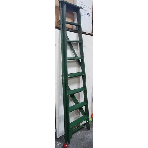 630 - A tall  A frame wooden step ladder with eight steps and finished in a lovely green colour.