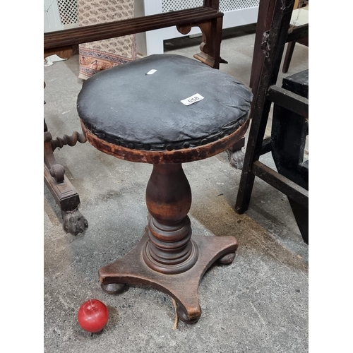 658 - An Antique Victorian mahogany stool with quadruped base, turned wood stand and waxed canvas cushion ... 