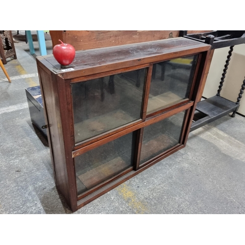 664 - A beautiful antique wall mounting display cabinet with four sliding glass doors. Four compartments i... 