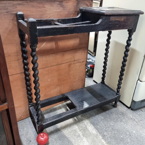 665 - A Victorian ebonised hall stand with barely twist supports, space for foot pedal and machine and add... 