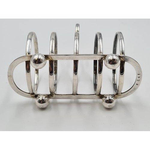 3 - Star Lot: A very fine collection of four sterling silver four-rack toasters, each set on pawed feet ... 