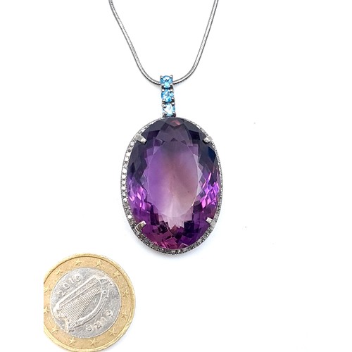 55 - Star lot : A hugely  impressive  32 carat Amethyst and Diamond pendant, set with a Halo of Diamonds ... 