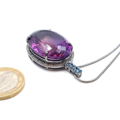 55 - Star lot : A hugely  impressive  32 carat Amethyst and Diamond pendant, set with a Halo of Diamonds ... 