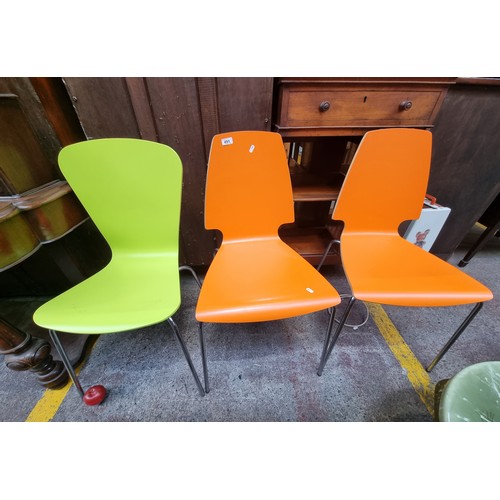 491 - Three brightly coloured ikea dining chairs with wooden seat and chrome tube legs. They look in almos... 