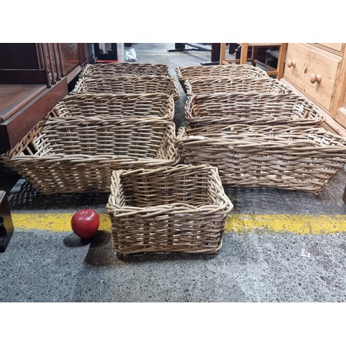 579 - Nine woven reed baskets, including eight large examples and one smaller example. All matching. Might... 