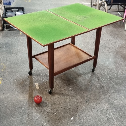 589 - A very attractive mid-century two tier drinks trolley, held on castors by EastCraft Scotland. Folds ... 