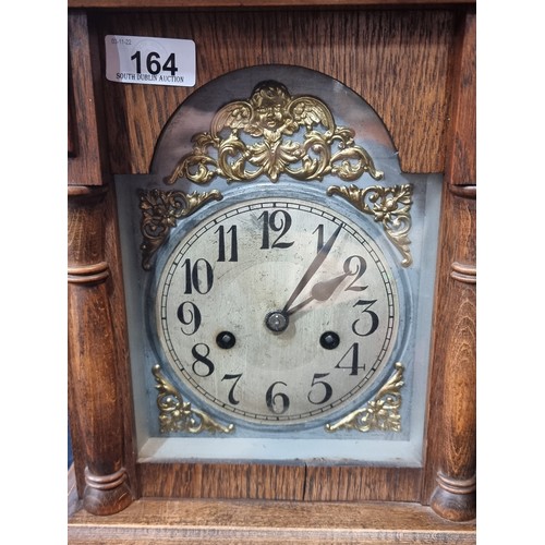 164 - A handsome antique eight-day mantle clock, housed in an attractive oak case, with original winder an... 