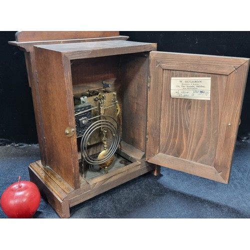 164 - A handsome antique eight-day mantle clock, housed in an attractive oak case, with original winder an... 