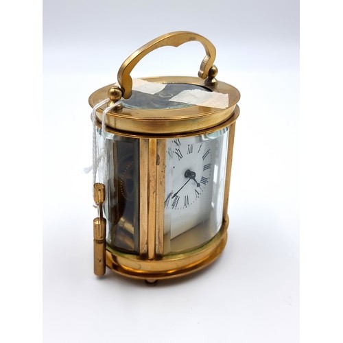 817 - A fine example of a brass carriage clock, featuring a white enamel face and roman numeral dial. This... 