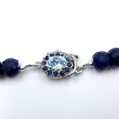 825 - A beautiful facet cut Sapphire graduated necklace, set with a striking Topaz clasp and Sapphire ster... 