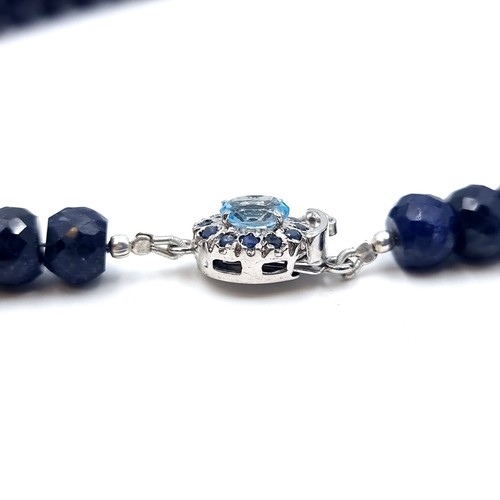 825 - A beautiful facet cut Sapphire graduated necklace, set with a striking Topaz clasp and Sapphire ster... 