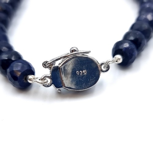 825 - A beautiful facet cut Sapphire graduated necklace, set with a striking Topaz clasp and Sapphire ster... 