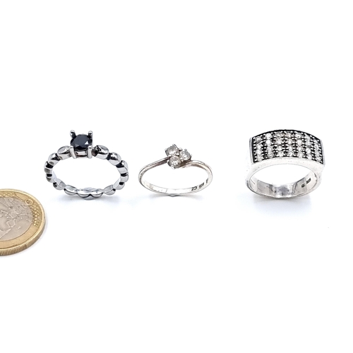 10 - An excellent collection of three sterling silver rings, comprising of two examples with Cubic Zircon... 