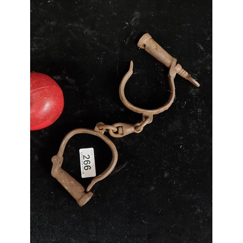 266 - A cast iron pair of antique hand cuffs  (shackles) . A good pair with key included. Circa 19th centu... 