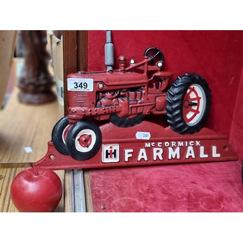 349 - An cast metal advertising plaque for McCormick Farmall tractors. This example is in a form of a trac... 