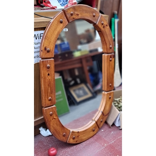 359 - A very impressive large mirror housed in an impressive wood frame with stud detail. H116cm x W80cm