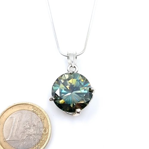 45 - A show stopping and generous Ocean Blue facet cut Moissanite pendant of 15.8 carats, set with a ster... 