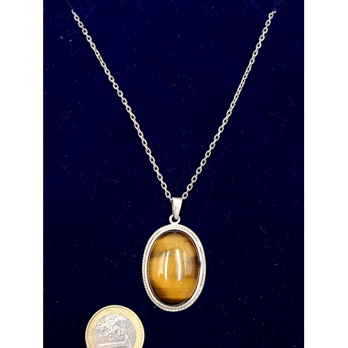 543 - A good example of a Tigers Eye pendant, which is set in sterling silver with sterling silver chain. ... 