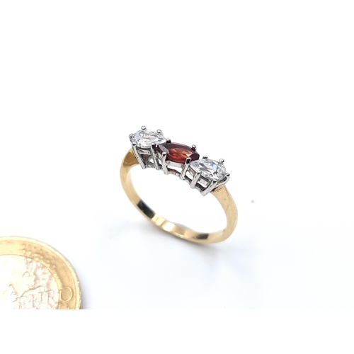 660 - A beautiful 9 carat Gold oval Garnet stone ring, featuring a tear drop White Sapphire stone setting.... 