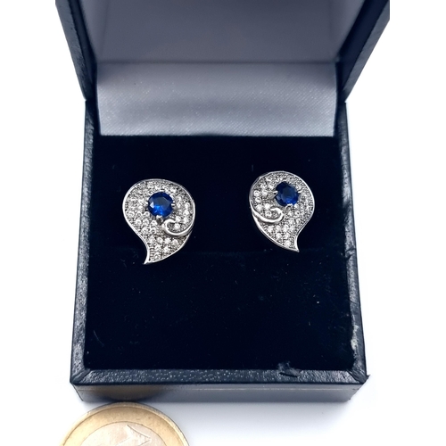 661 - A sparkling pair of Sapphire earrings, set with a beautiful gem stone setting and set in sterling si... 