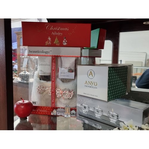 667 - Four lovely giftsets including an Aynsley Christmas cake slice and an Anyu Fine Porcelain vase, all ... 