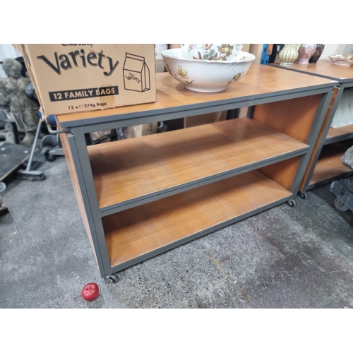 687 - A high quality storage trolley with three shelves and push handles to side held on castors. L132 x W... 