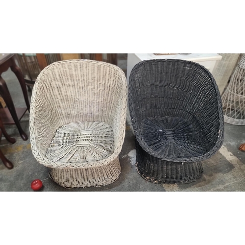 712 - Two garden wicker armchairs one in black and one in white.