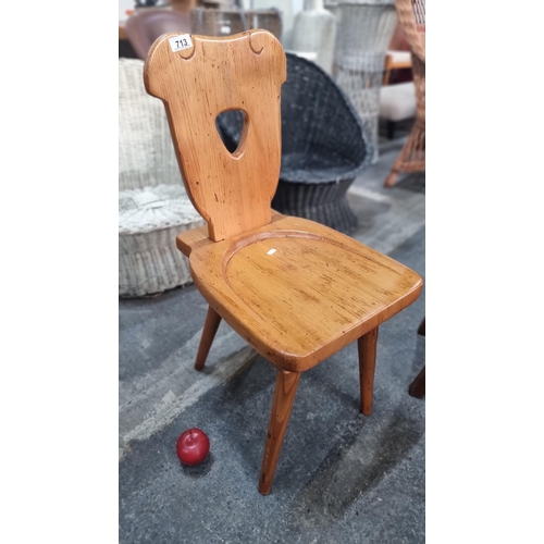 713 - A vintage charming solid wood children's chair with carved wood back.