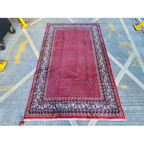 737 - Star Lot : A stunning large hand knotted, wool rug. This authentic piece is beautifully decorated in... 