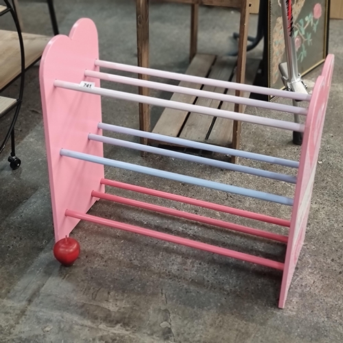 741 - A delightful children's shoe rack with three tiers for storage.