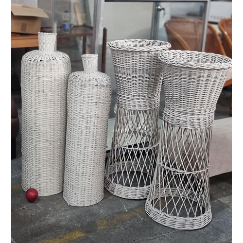 745 - A pair of white wicker planters including and two tall vases. (4)